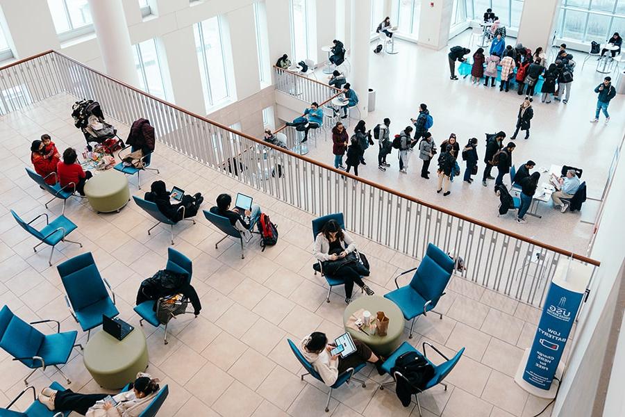 top view of students sitting casually at tables in UMass Boston Campus Center
